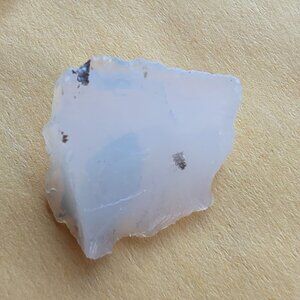Raw white opal sample chip for display